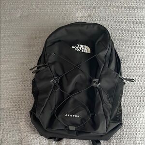 The North Face Black Backpack with Bungee Cord and Durable Design